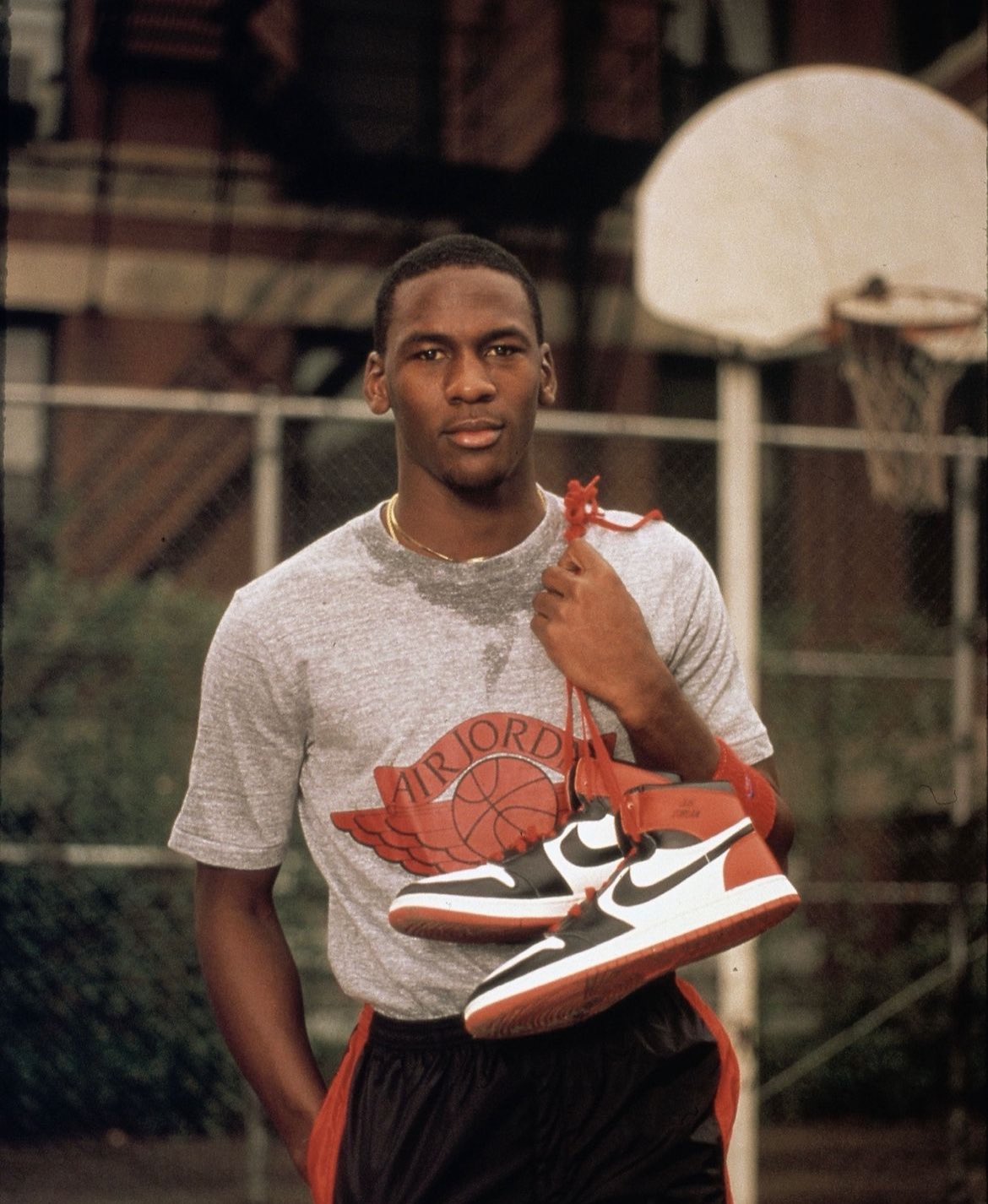 Michael Jordan as a Rookie holding the Jordan 1 Sneakers